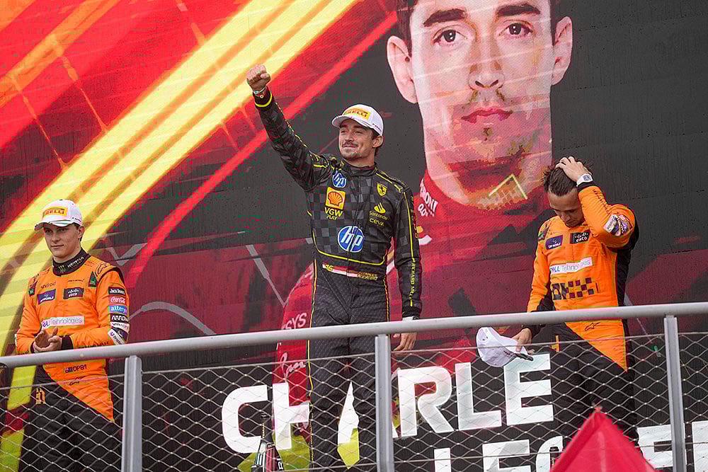 | Photo: AP/Luca Bruno : Italian Grand Prix 2024: Ferrari driver Charles Leclerc, centre, celebrates on the podium with second placed McLaren driver Oscar Piastri left, and third McLaren driver Lando Norris